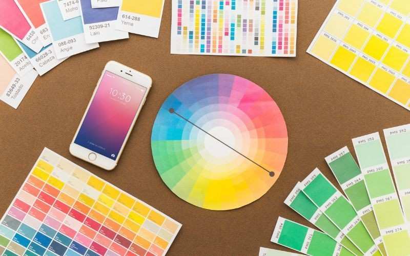 Color swatches and smartphone on table.